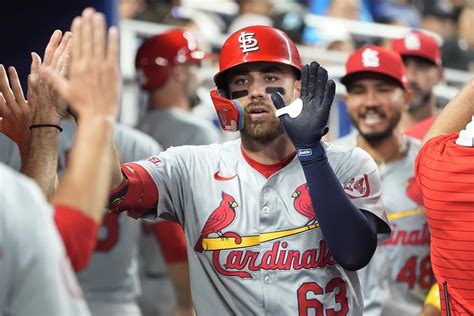 Winn's homer in 12th, Carlson's throw lead Cardinals over Marlins .